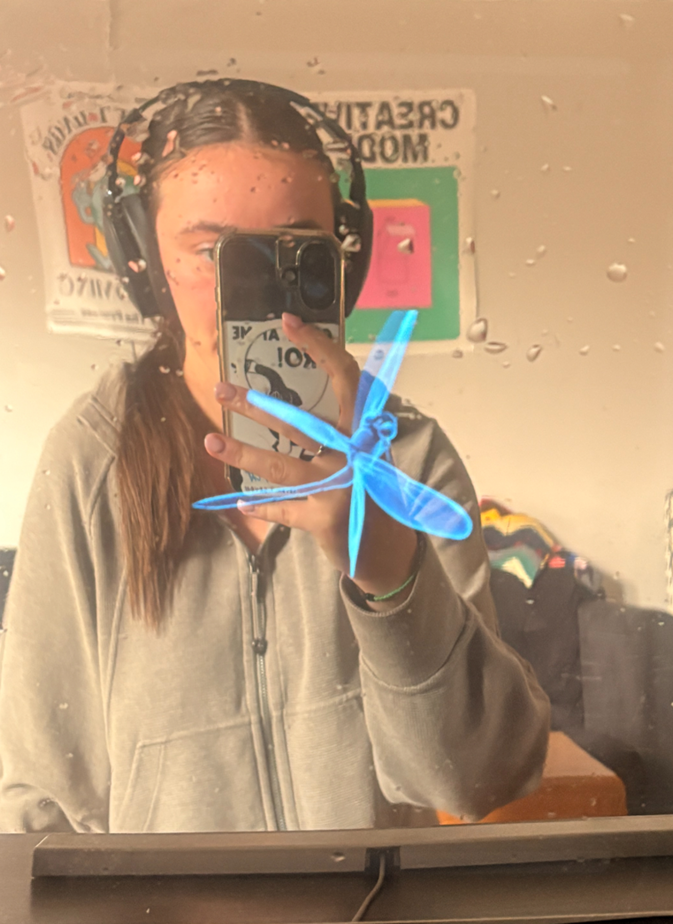 This is a prototype of what we envision our ideal mirror with an integrated display to look like. We used a plexiglass sheet from a picture frame and applied mirror film over its surface to simulate a two-way mirror. This setup allows the prototype to maintain a clear mirror reflection while also enabling the monitor display behind it to remain visible through the surface. The result demonstrates how the mirror can function both as a reflective surface and as a screen for digital content.